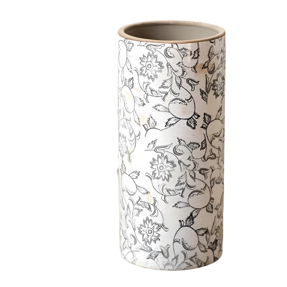 Cylindrical ceramic vase with floral and elephant pattern on a wooden surface