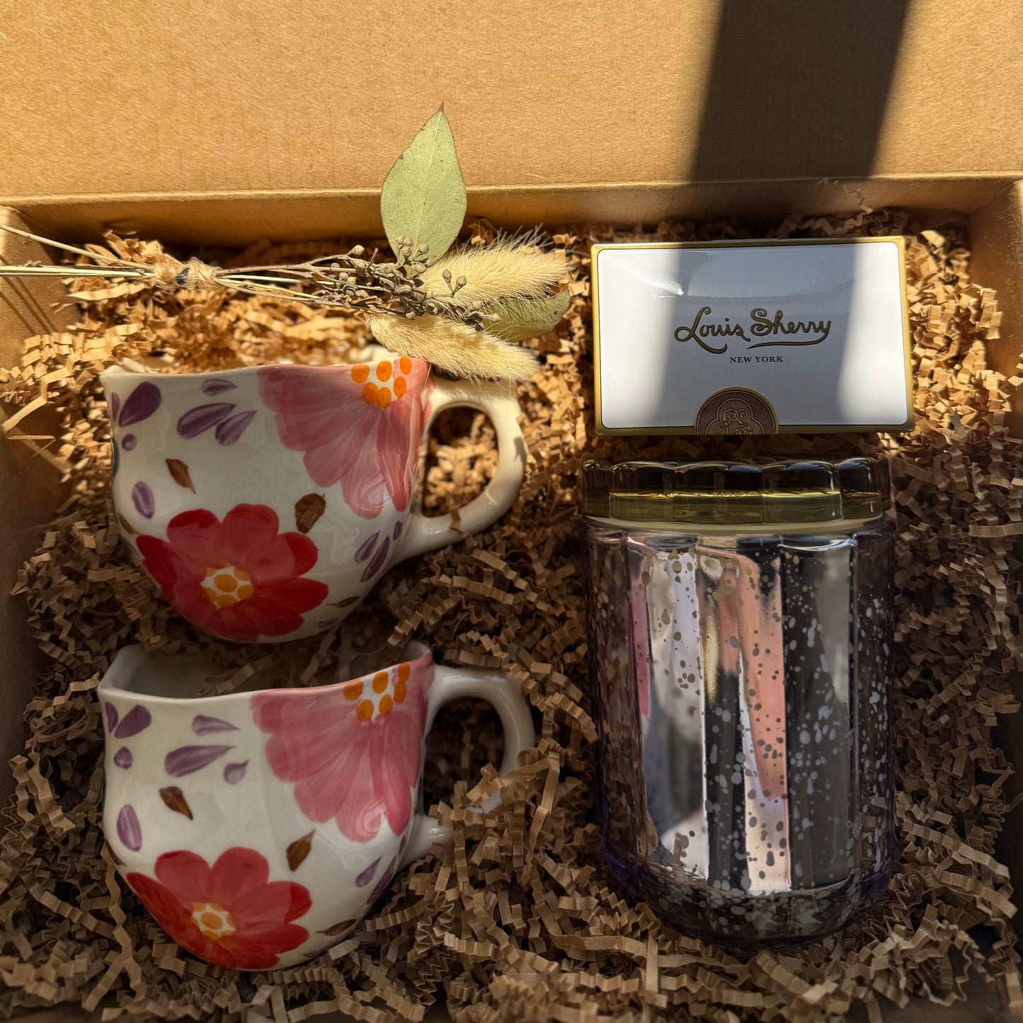 Two floral-patterned mugs and a candle in a box with 'The Fox and Pantry' branding.