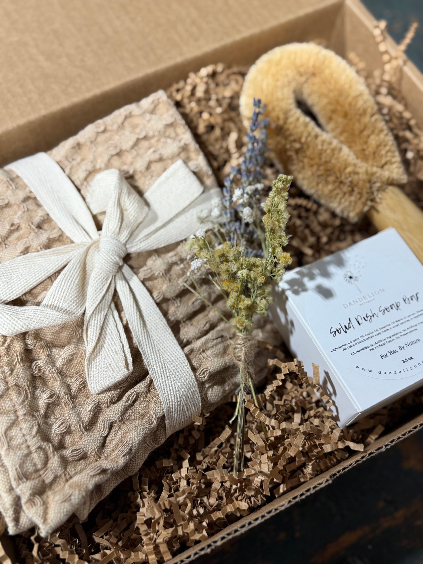 Gift set with knitted blanket, brush, and lavender in a box