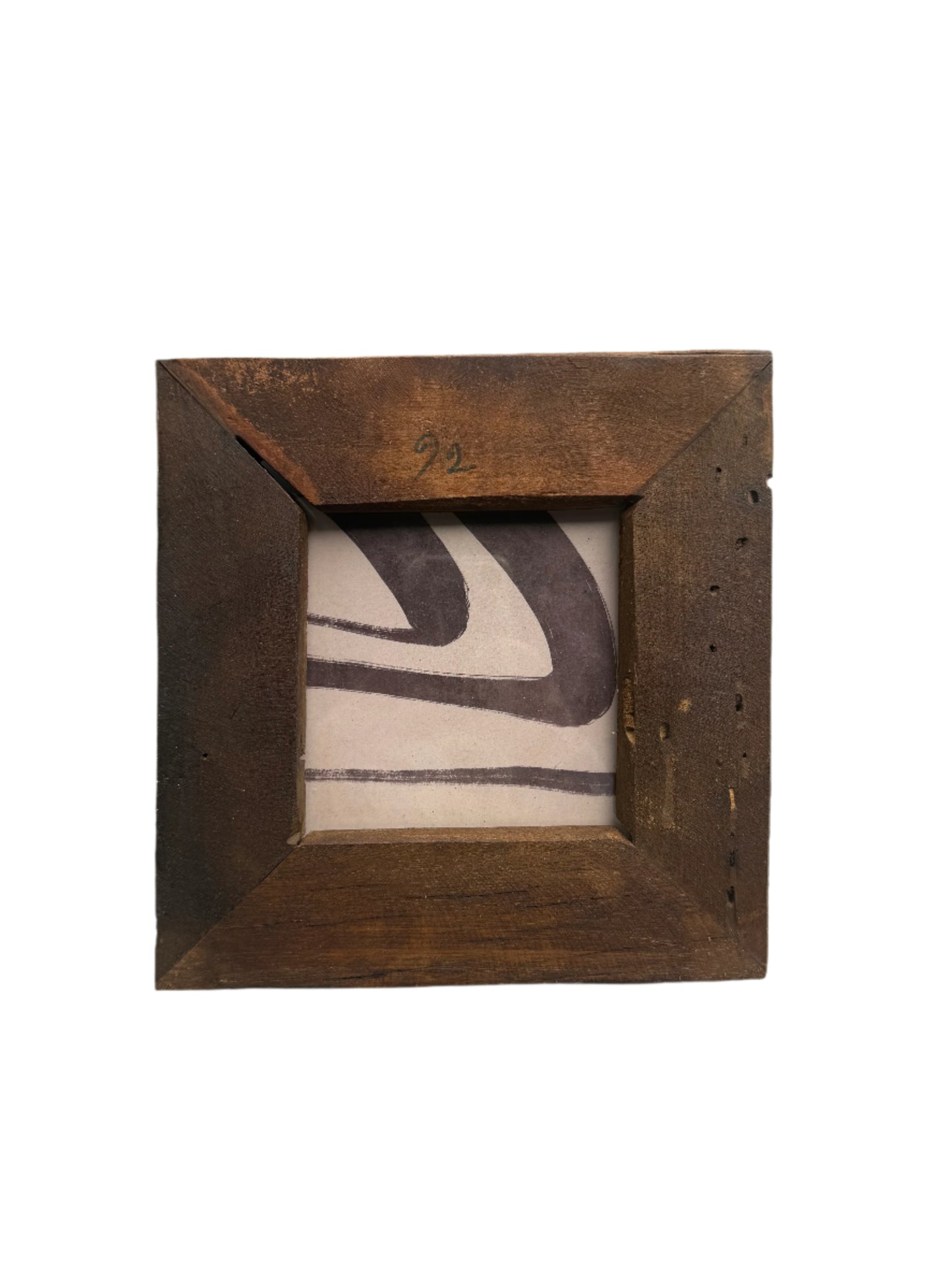 Wooden picture frame with a ceramic tile featuring abstract black design on a white background