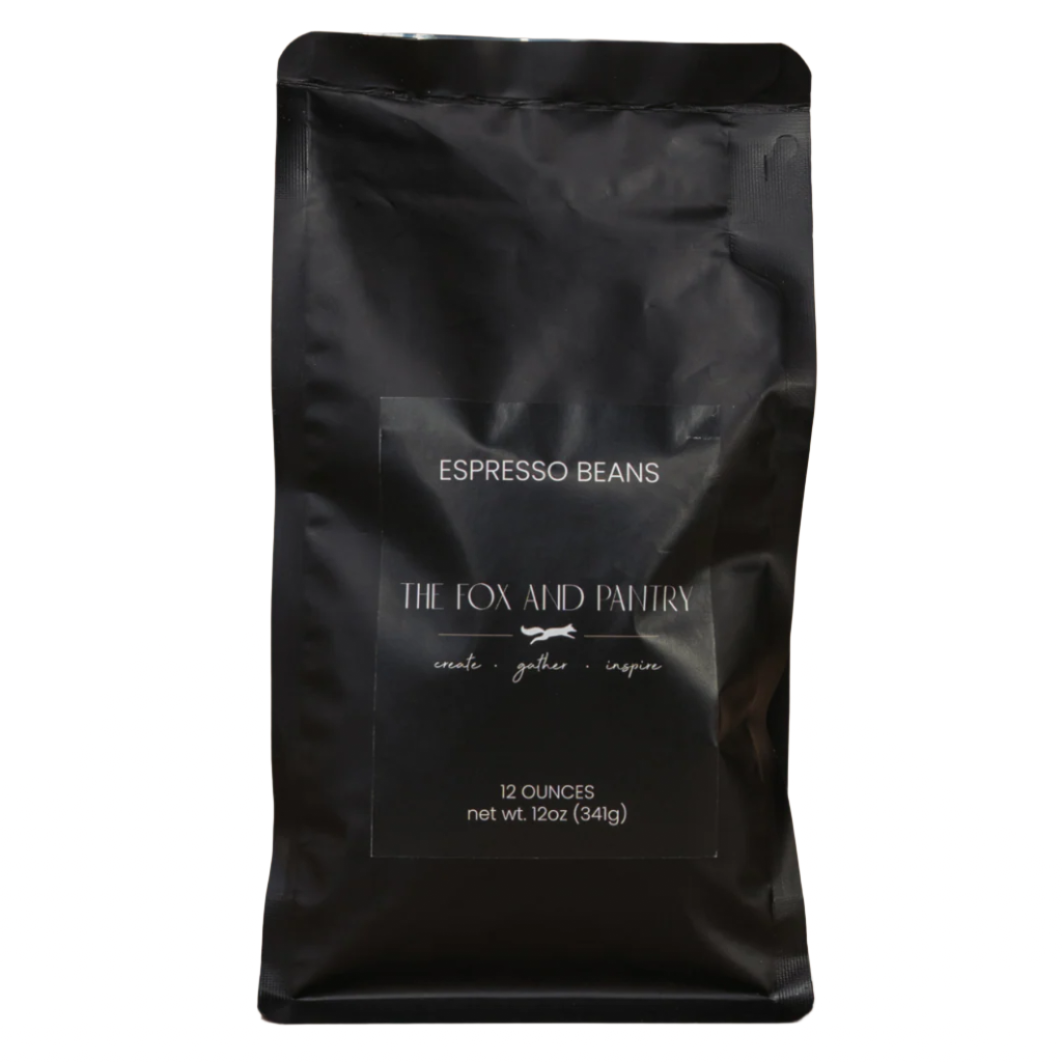 Black bag of espresso beans from The Fox and Pantry on a brown background