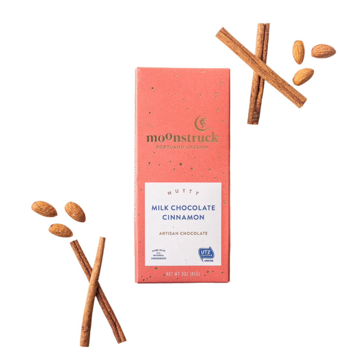 Moonstruck Milk Chocolate Cinnamon bar with cinnamon sticks and ground cinnamon on a white background