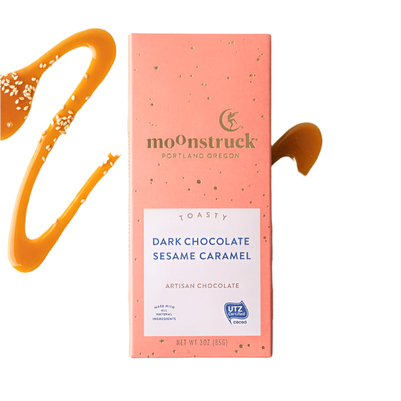 Moonstruck dark chocolate sesame caramel bar packaging on a white background with caramel drizzle.