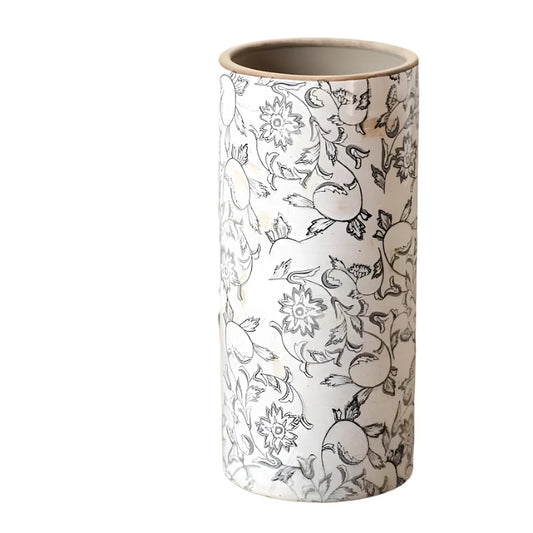 Cylindrical ceramic vase with floral and elephant pattern on a wooden surface