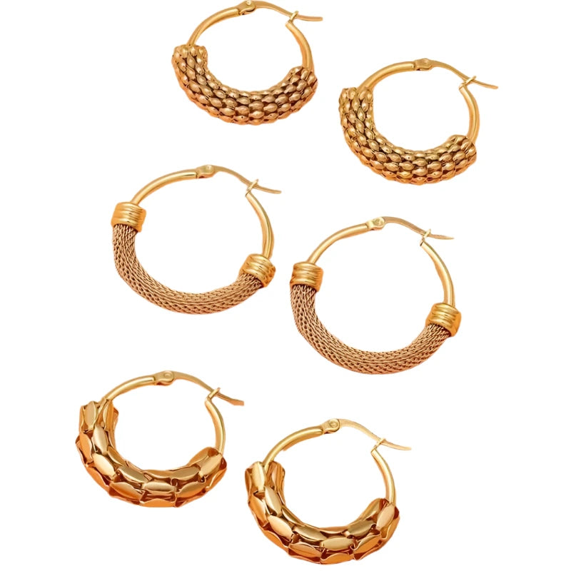 Set of gold hoop earrings on a peach background