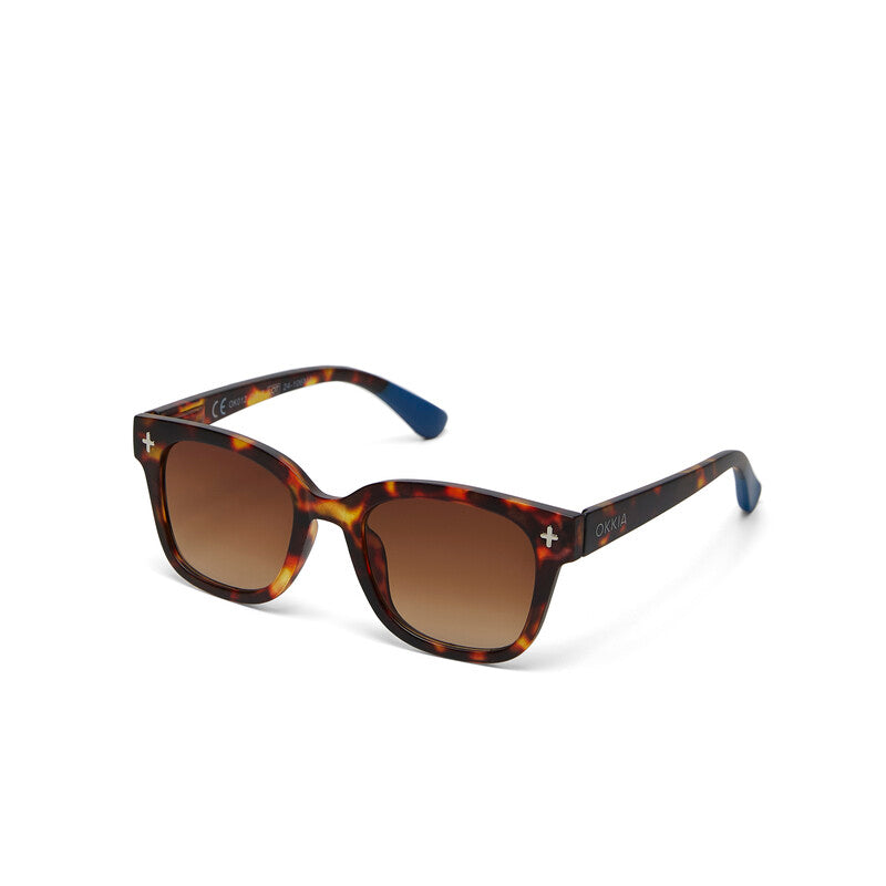 Sunglasses with tortoiseshell frame and brown lenses on a white background