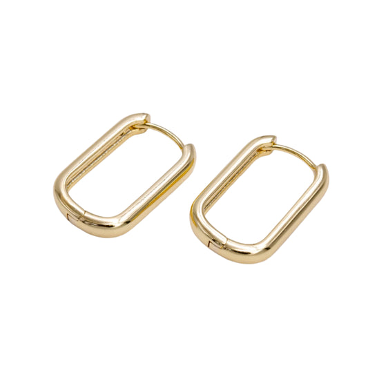 Gold hoop earrings on a light gray background