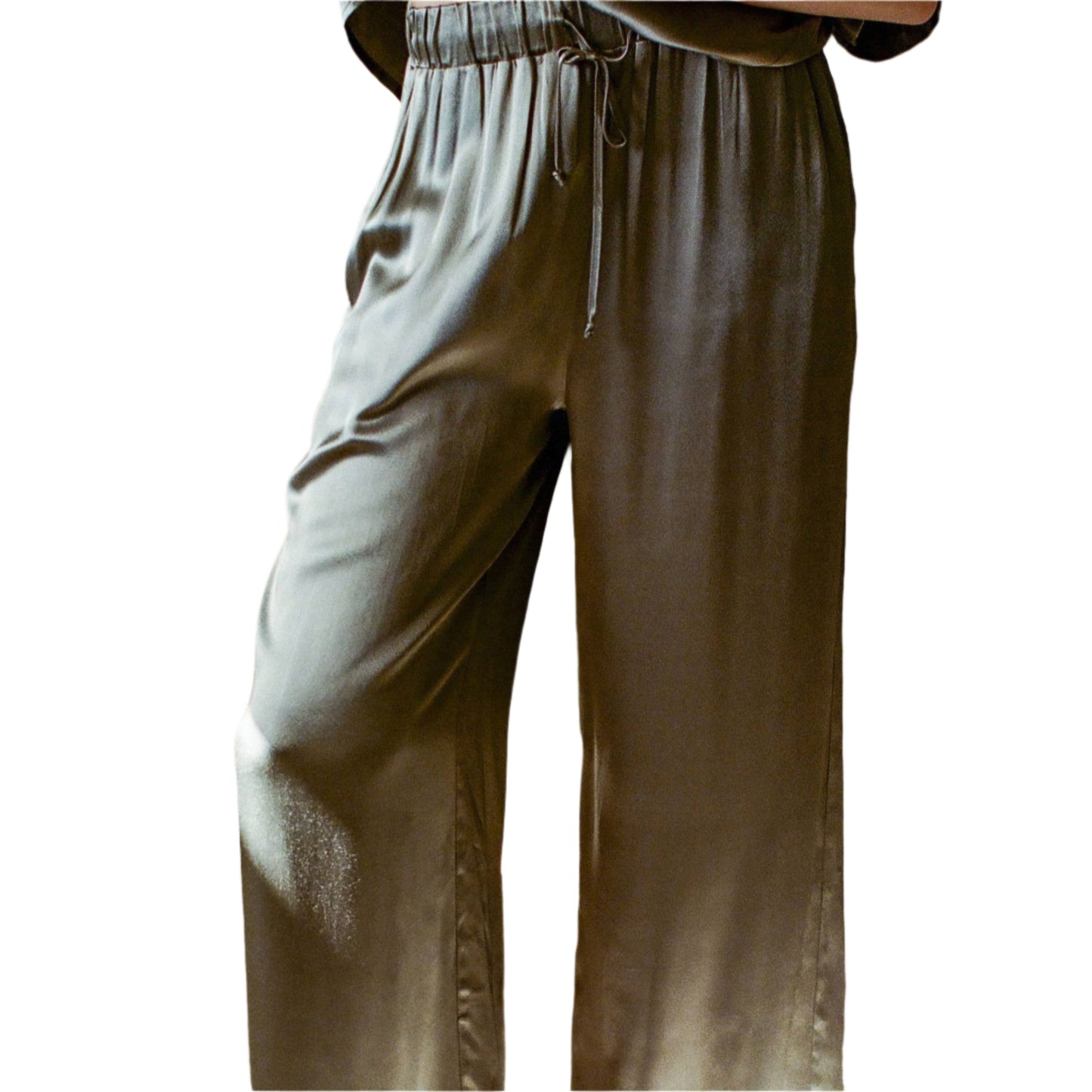 Person wearing olive green wide-leg pants standing on a light-colored floor.