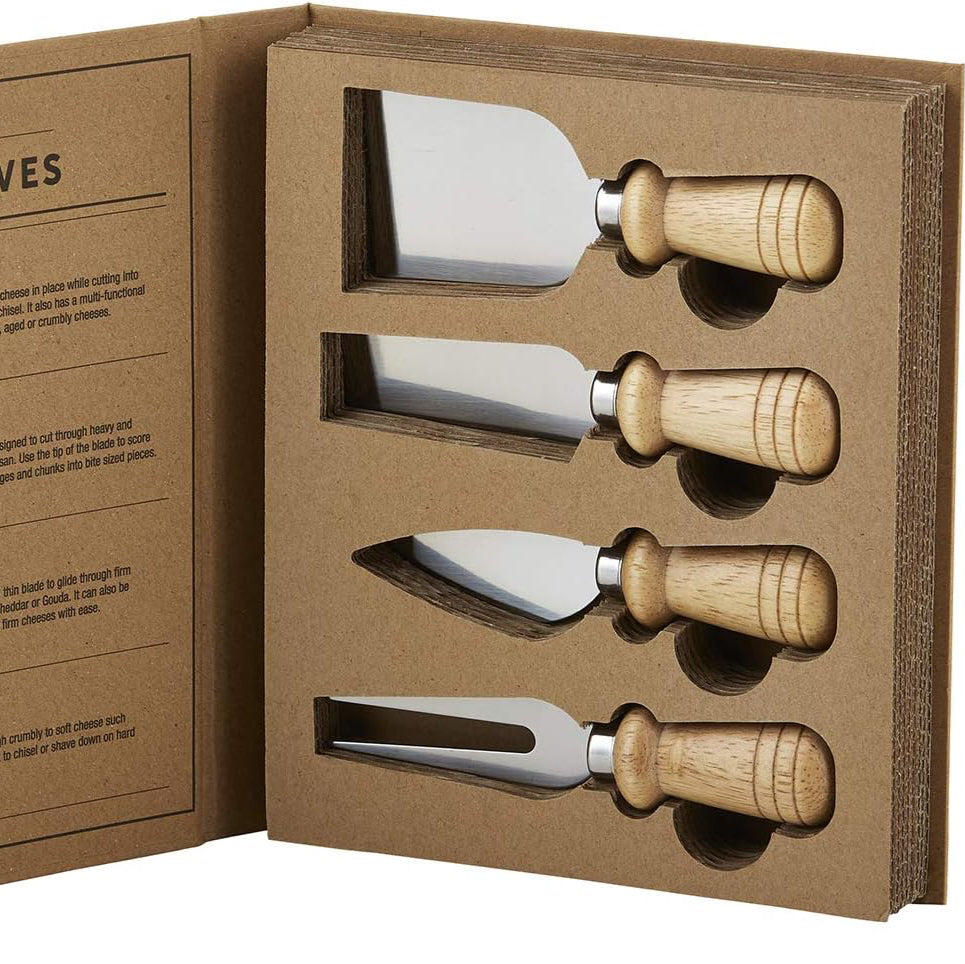 Set of four cheese knives with wooden handles in a cardboard box, featuring an open manual on the left.