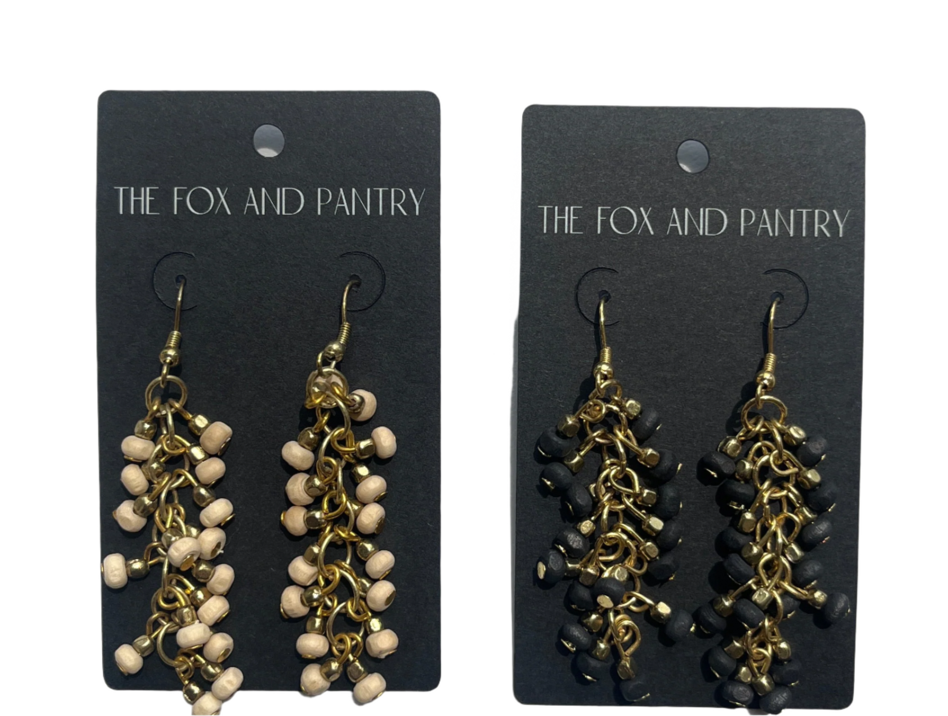 Pair of earrings on 'The Fox and Pantry' branded cards against a light gray background
