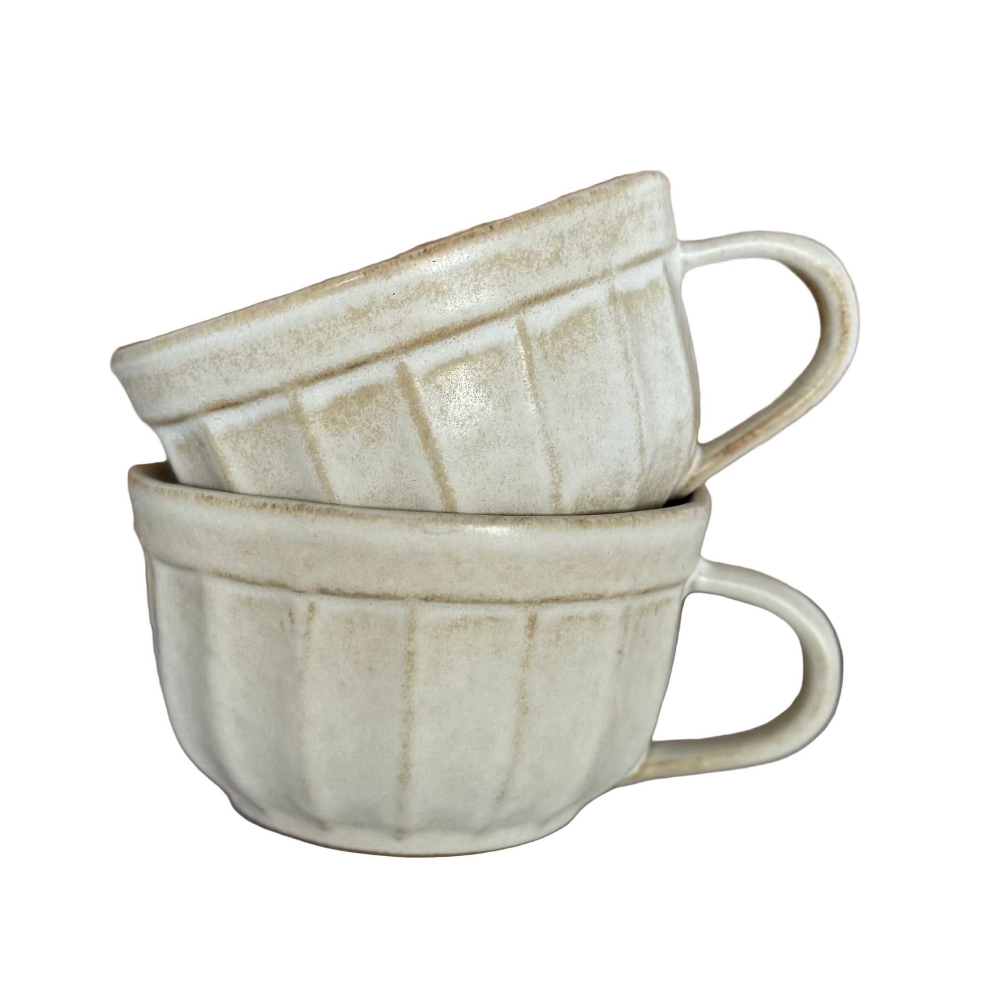 Two ceramic mugs stacked on a neutral background