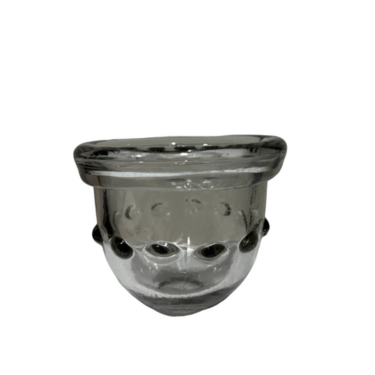 Clear glass candle holder with black accents on a white surface