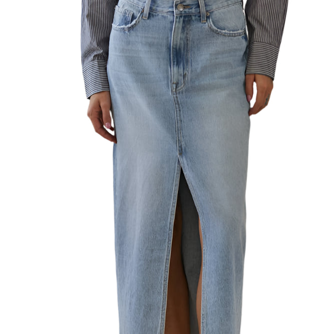 Person wearing a light blue denim skirt with a minimal background