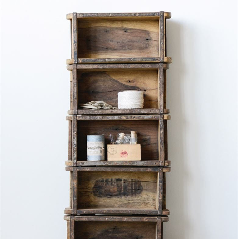 Stack of wooden crates with items on a light background