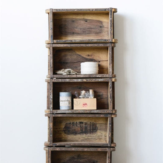 Stack of wooden crates with items on a light background