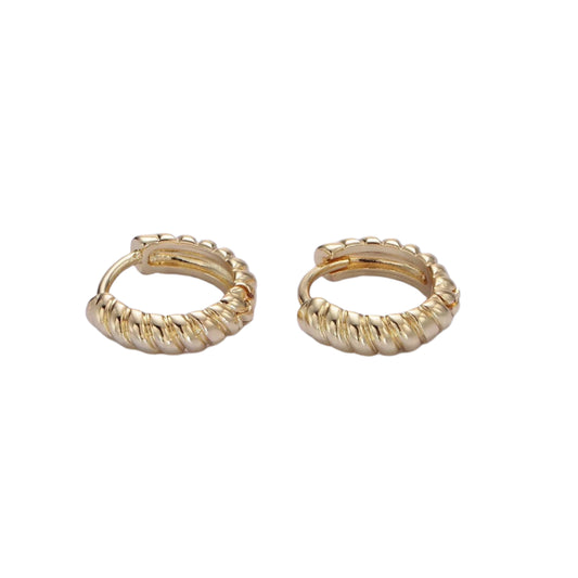 Pair of gold hoop earrings on a light purple background