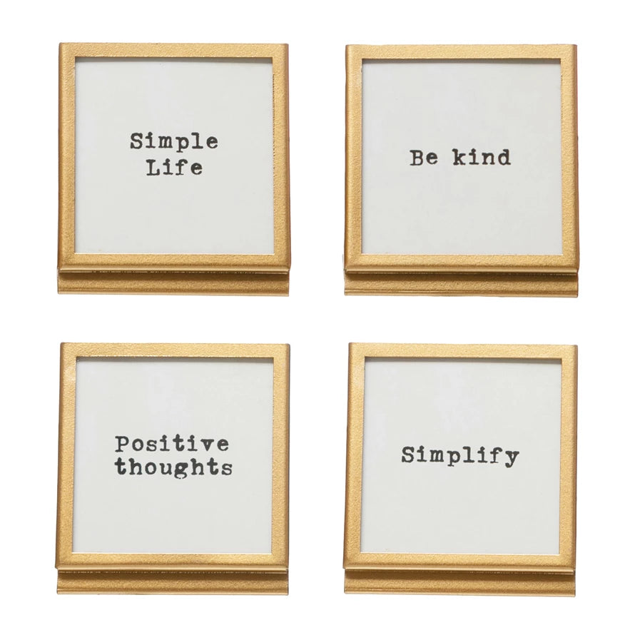 Four wooden frames with motivational phrases on a white background