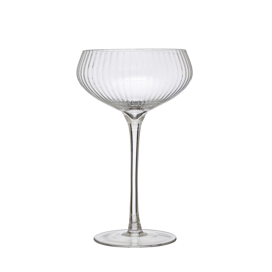 Clear glass cocktail glass on a white background