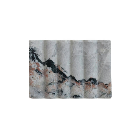 Rectangular stone with a textured surface on a white background