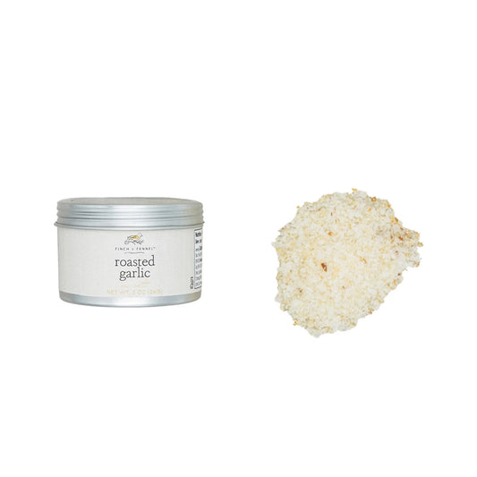 Tin of roasted garlic seasoning with a scoop of the product on a white background