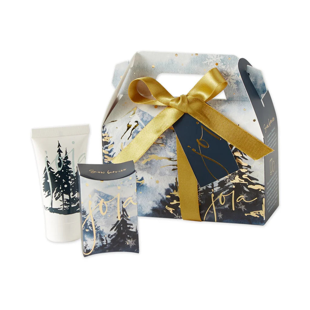 Gift set with a box, candle, and card featuring a winter landscape design.