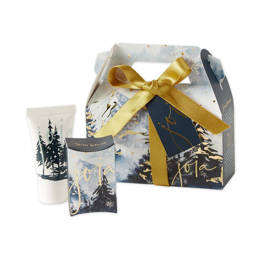 Gift set with a box, candle, and card featuring a winter landscape design.